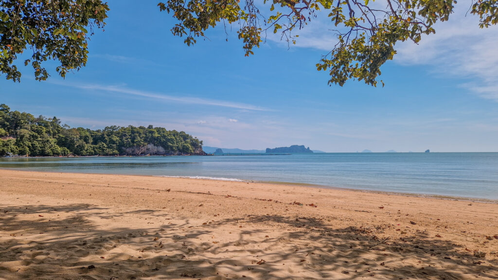Weitläufiger leerer Sandstrand auf Koh Yao Noi mit Türkisblauem Meer und Dschungel, Thailand